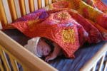 baby sleeping on natural latex crib mattress