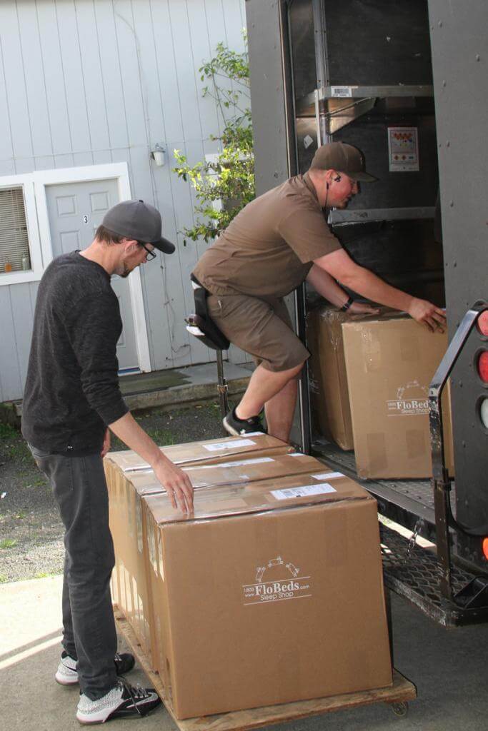 Delivery driver delivering a latex mattress from FloBeds